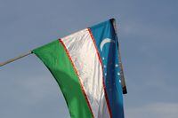 FILE PHOTO: An Uzbek flag with a black ribbon hangs in commemoration of Uzbekistan's late President Islam Karimov as people gather to pay tribute in Tashkent, Uzbekistan, September 3, 2016. REUTERS/Muhammadsharif Mamatkulov/File Photo