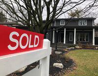 A real estate sold sign is shown in Oakville, Ont., on Sunday, Dec.20, 2020. A report by Re/Max Canada forecasts the national average home sale price in Canada will fall 2.2 per cent in the final months of the year. THE CANADIAN PRESS/Richard Buchan