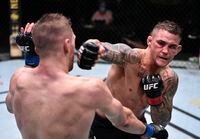 June 27, 2020; Las Vegas, NV, USA; Dustin Poirier (red gloves) punches Dan Hooker of New Zealand (blue gloves) during UFC Fight Night at the UFC APEX. Mandatory Credit: Chris Unger/Zuffa LLC via USA TODAY Sports