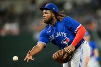 Toronto Blue Jays first baseman Vladimir Guerrero Jr. tosses the ball to first to put put Baltimore Orioles' Cedric Mullins during the seventh inning of a baseball game, Monday, Aug. 8, 2022, in Baltimore. (AP Photo/Nick Wass)