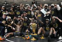 Hamilton Honey Badgers players and team members celebrate with the Championship trophy after defeating the Scarborough Shooting Stars in the CEBL championship final, Sunday, August 14, 2022 in Ottawa.  THE CANADIAN PRESS/Adrian Wyld