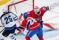 Montreal Canadiens goaltender Sam Montembeault stops Winnipeg Jets' Paul Stastny (25) as Canadiens' Christian Dvorak defends during second period NHL hockey action in Montreal, Monday, April 11, 2022. THE CANADIAN PRESS/Graham Hughes