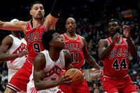 Toronto Raptors forward OG Anunoby (3) looks for the shot under guard from Chicago Bulls center Nikola Vucevic (9) as teammates DeMar DeRozan (11) and Patrick Williams (44) look on during second half NBA basketball action in Toronto, Monday, Oct. 25, 2021. THE CANADIAN PRESS/Nathan Denette