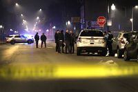 CHICAGO, ILLINOIS - OCTOBER 31:  Police investigate the scene where as many as 14 people were reported to have been shot on October 31, 2022 in Chicago, Illinois. Three juveniles were among those reported to have been wounded in the drive-by shooting, according to published reports.  (Photo by Scott Olson/Getty Images)