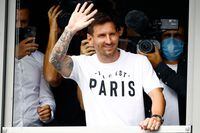 Argentinian football player Lionel Messi waves to supporters from a window after he landed on August 10, 2021 at Le Bourget airport, north of Paris, to become Paris Saint-Germain's new player following his departure from Barcelona, the club he has represented for the entirety of his 17-year professional career so far. - Asked by reporters at Barcelona's El Prat airport if the Argentine star would later on sign with the French club, Jorge Messi, the father and player's agent, said: "Yes". (Photo by Sameer Al-DOUMY / AFP) (Photo by SAMEER AL-DOUMY/AFP via Getty Images)