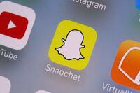 FILE - The Snapchat app is seen on a mobile device in New York, Aug. 9, 2017. As concerns about social media's impact on teen psychology continue to rise, platforms from Snapchat to TikTok to Instagram are bolting on new features they say will make their services safer and more age appropriate. (AP Photo/Richard Drew, File)