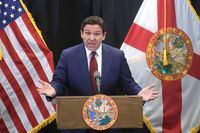 Florida Gov. Ron DeSantis delivers remarks during a press conference at the Central Florida Tourism Oversight District headquarters at Walt Disney World, in Lake Buena Vista, Fla., Thursday, Feb. 22, 2024. Almost a year after Florida lawmakers passed a law giving Florida’s governor control over Walt Disney World’s governing district, DeSantis on Thursday called the takeover a success, despite an exodus of workers, ongoing litigation and scandal surrounding one of his appointees. (Joe Burbank/Orlando Sentinel via AP)