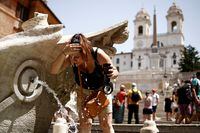 A woman cools off at Fontana della Barcaccia at the Spanish Steps in Rome, Italy.