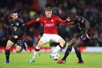 MANCHESTER, ENGLAND - DECEMBER 12: Rasmus Hojlund of Manchester United battles for possession with Dayot Upamecano of Bayern Munich during the UEFA Champions League match between Manchester United and FC Bayern München at Old Trafford on December 12, 2023 in Manchester, England. (Photo by Michael Steele/Getty Images)