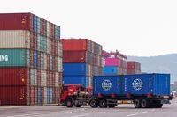 A truck transports containers at a port in Qingdao, in China's eastern Shandong province on July 13, 2022. (Photo by AFP) / China OUT (Photo by STR/AFP via Getty Images)