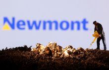 FILE PHOTO: FILE PHOTO: A small toy figure and gold imitation are seen in front of the Newmont logo in this illustration taken November 19, 2021. REUTERS/Dado Ruvic/Illustration/File Photo