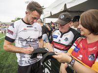 The Toronto Wolfpack's Ryan Brierley and other squad members gets hugs and give autographs to fans following their match against the London Broncos at Lamport Stadium as the trans-Atlantic squad plots a course to promotion to rugby's superleague,  in Toronto, on Saturday June 9, 2018.(J.P. Moczulski/The Globe and Mail)