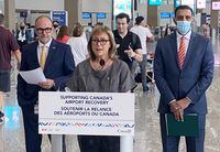 Parliamentary Secretary for Transport and Liberal MP Annie Koutrakis, centre, speaks as Calgary Airport Authority CEO Bob Sartor, left, and Liberal MP George Chahal look on during a funding announcement in Calgary on Tuesday, August 23, 2022. THE CANADIAN PRESS/Bill Graveland