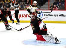 Ottawa Senators goaltender Cam Talbot (33) makes a save as the puck rebounds off his shoulder during third period NHL hockey action against the Boston Bruins in Ottawa, on Tuesday, Dec. 27, 2022. THE CANADIAN PRESS/Justin Tang