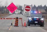 Police block the road on County Road 17 in Kawartha Lakes, Ont., Friday, Nov. 27, 2020. Ontario's police watchdog agency says seven investigators are probing an incident in which a child was shot dead and two others, including an officer, injured. THE CANADIAN PRESS/Fred Thornhill