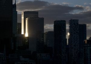 The setting sun reflects off the glass walls of two office buildings in Toronto’s Financial District as the sun sets on Nov 7, 2022. Fred Lum/The Globe and Mail.