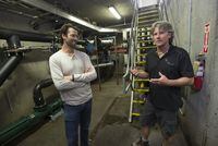 EverGen CEO Chase Edgelow, left, and GrowTEC founder and co-owner Chris Perry, right, speak during a tour in the processing basement of the GrowTEC anaerobic digesters at The Perry Farm in Chin, Alta. on Wednesday, July 20, 2022.