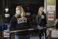 Olympian Hayley Wickenheiser reacts as a vehicle approaches the donation drive for personal protective equipment at XYZ Storage in Toronto on Saturday, April 11, 2020, amid the COVID-19 global pandemic. THE CANADIAN PRESS/Tijana Martin
