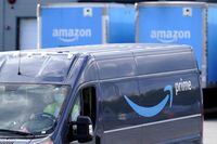 FILE - An Amazon Prime logo appears on the side of a delivery van as it departs an Amazon Warehouse location in Dedham, Mass., Oct. 1, 2020. Amazon said Monday, Oct. 10, 2022, that it will invest 1 billion euros ($972.1 million) to add thousands of more eclectic vans, long-haul trucks and cargo bikes to its delivery network in Europe. (AP Photo/Steven Senne, File)