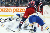 Dec 14, 2021; Winnipeg, Manitoba, CAN;  Buffalo Sabres goalie Ukko Pekka Luukkonen (1) makes a save on a shot by Winnipeg Jets forward Pierre-Luc Dubois (80) during the second period at Canada Life Centre. Mandatory Credit: Terrence Lee-USA TODAY Sports