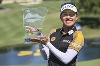 Atthaya Thitikul, of Thailand, holds her trophy after winning the LPGA Walmart NW Arkansas Championship golf tournament, Sunday, Sept. 25, 2022, in Rogers, Ark. (AP Photo/Michael Woods)