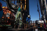 FILE -- Floorhands work on a drilling rig contracted to Shell in the Delaware Basin, near Wink, Texas, on Jan. 25, 2019. Royal Dutch Shell sold its oil and gas production in the Permian Basin, the biggest American oil field, to ConocoPhillips for $9.5 billion in cash on Monday, Sept. 20, 2021. (Tamir Kalifa/The New York Times)