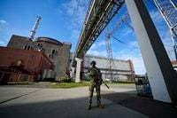 FILE - A Russian serviceman guards in an area of the Zaporizhzhia Nuclear Power Station in territory under Russian military control, southeastern Ukraine, Sunday, May 1, 2022. After more than four months of ferocious fighting, Russia claimed a key victory: full control over one of the two provinces in Ukraine's eastern industrial heartland. This photo was taken during a trip organized by the Russian Ministry of Defense. (AP Photo, File)