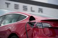 FILE - A 2021 Model 3 sedan charges at a Tesla dealership in Littleton, Colo., on June 27, 2021. Electric vehicle sales nearly doubled in the U.S. and worldwide in 2021. (AP Photo/David Zalubowski, File)