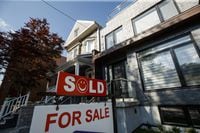 A Sold sign sits in front of a house in Toronto on Tuesday July 12, 2022. THE CANADIAN PRESS/Cole Burston
