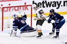 Vegas Golden Knights' William Karlsson (71) scores on Winnipeg Jets' goaltender Connor Hellebuyck (37) during second period game 4 NHL Stanley Cup first round hockey playoff action in Winnipeg, Monday, April 24, 2023. THE CANADIAN PRESS/Fred Greenslade