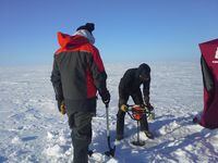Environment Canada researchers use an ice auger to drill a hole through the ice on Great Slave Lake, March 2014. Sediment cores collected during the expedition have been used to study changes in the microscopic life forms that inhabit the lake over time.Credit: M.Evans