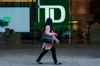 A person walks past a TD Bank sign in the financial district in Toronto on Tuesday, Sept. 20, 2022. BDC today announced the launch of Thrive Venture Fund and Lab for Women, a $500-million investment platform that will support the growth and economic impact of Canadian women-led businesses. THE CANADIAN PRESS/Alex Lupul