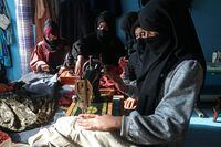 Afghan women sew clothes at a tailor shop in the Fayzabad district of Badakhshan province on December 13, 2023. (Photo by OMER ABRAR / AFP) (Photo by OMER ABRAR/AFP via Getty Images)