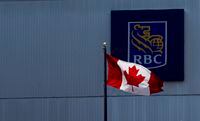 A Canadian flag flies near a branch of the Royal Bank in Ottawa, Monday, July 6, 2020. Royal Bank of Canada says it is dropping its partnership with WE Charity and will no longer sponsor or donate to the organization. THE CANADIAN PRESS/Adrian Wyld