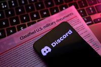 A mockup representation of classified U.S. military documents and the Discord logo are seen in this illustration taken April 13, 2023. REUTERS/Dado Ruvic/Illustration