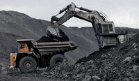 FILE PHOTO: A machine loads a BelAZ dump-body truck with coal at the Chernigovsky opencast colliery, outside the town of Beryozovsky, Kemerovo region, Siberia, Russia, April 4, 2016. REUTERS/Ilya Naymushin