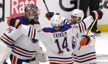 Edmonton Oilers goalie Stuart Skinner, left, celebrates with teammates Mattias Ekholm (14) and Darnell Nurse after the team's win over the Los Angeles Kings in Game 6 of an NHL hockey Stanley Cup first-round playoff series in Los Angeles on Saturday, April 29, 2023. (Keith Birmingham/The Orange County Register via AP)