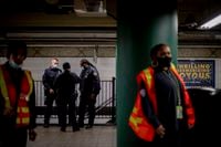 FILE — Police officers at a subway station following an earlier shooting on a subway train in Brooklyn, April 12, 2022. Crime rates on trains and buses are up in some of the nation’s biggest cities, one more barrier for downtowns trying to rebound. (Hilary Swift/The New York Times) 