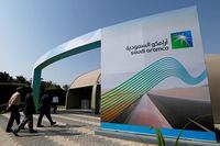 FILE PHOTO: The logo of Aramco is seen as security personnel walk before the start of a press conference by Aramco at the Plaza Conference Center in Dhahran, Saudi Arabia November 3, 2019. REUTERS/Hamad I Mohammed/File Photo