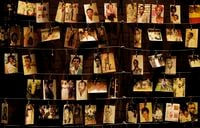 In this April 5, 2019, file photo, family photographs of some of those who died hang on display in an exhibition at the Kigali Genocide Memorial centre, in Kigali, Rwanda.
