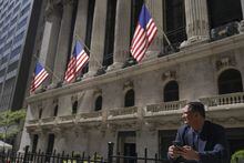 A trader stands outside the New York Stock Exchange, Friday, Sept. 23, 2022.