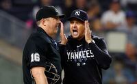 New York Yankees manager Aaron Boone talks to umpire Lance Barrett (16) during the second inning of the team's baseball game against the Toronto Blue Jays, Wednesday, Sept. 20, 2023, in New York. (AP Photo/Noah K. Murray)