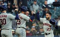 CHICAGO, ILLINOIS - OCTOBER 12:  Jose Altuve #27 of the Houston Astros is congratulated by Michael Brantley #23 and Kyle Tucker #30 after hitting a 3-run home run during the 9th inning of Game 4 of the American League Division Series against the Chicago White Sox at Guaranteed Rate Field on October 12, 2021 in Chicago, Illinois. (Photo by Jonathan Daniel/Getty Images)