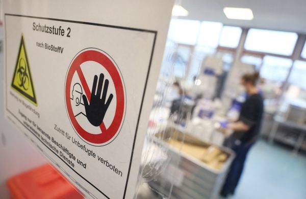 Warning signs are seen at a COVID-19 testing lab in Ingelheim, Germany. KAI PFAFFENBACH/REUTERS