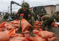 Members of the Canadian Forces prepare sandbags for distribution to residents threatened by floodwaters Wednesday, April 24, 2019 in Gatineau, Que. Canada underestimates the risk domestic emergency operations pose to the mental health of responding military personnel, a report from the Armed Forces ombudsman has found. THE CANADIAN PRESS/Adrian Wyld
