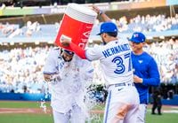 TORONTO, ON - JUNE 4: Vladimir Guerrero Jr. #27 of the Toronto Blue Jays gets water dumped on him by teammate Teoscar Hernandez #37 after their team defeated the Minnesota Twins at the Rogers Centre on June 4, 2022 in Toronto, Ontario, Canada. (Photo by Mark Blinch/Getty Images)