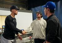 New York Yankees centre fielder Aaron Judge, left, meets with Toronto Maple Leafs players Auston Matthews, centre, and Mitch Marner before playing against the Toronto Blue Jays in American League MLB baseball action in Toronto on Tuesday, September 27, 2022. THE CANADIAN PRESS/Nathan Denette