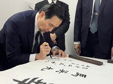 This handout picture taken and released by the office of former Taiwanese president Ma Ying-jeou on March 28, 2023 shows former Taiwanese president Ma Ying-jeou using a brush to write calligraphy at the Sun Yat-sen Mausoleum in Nanjing, in China's eastern Jiangsu province. - Ma travelled to China on March 27, 2023, embarking on the first cross-strait visit by a current or former leader of the island in more than seven decades, a trip Taipei's ruling party called "regrettable". (Photo by Handout / Ma Ying-jeou's office / AFP) / RESTRICTED TO EDITORIAL USE - MANDATORY CREDIT "AFP PHOTO / Ma Ying-jeou's office" - NO MARKETING NO ADVERTISING CAMPAIGNS - DISTRIBUTED AS A SERVICE TO CLIENTS (Photo by HANDOUT/Ma Ying-jeou's office/AFP via Getty Images)