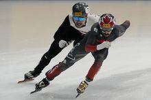Steven Dubois, right, of Canada competes against Roberts Kruzbergs of Latvia during the quarterfinal of the men's 1,500-meter at the ISU World Short Track Speed Skating Championships 2023 in Seoul, South Korea, Friday, March 10, 2023. (AP Photo/Ahn Young-joon)