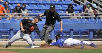 Detroit Tigers' Zach Short tags out Toronto Blue Jays' Jonathan Davis (3) trying to steal third base during the fifth inning of a spring training baseball game in Dunedin, Fla. on Sunday, March 28, 2021. THE CANADIAN PRESS/Steve Nesius
